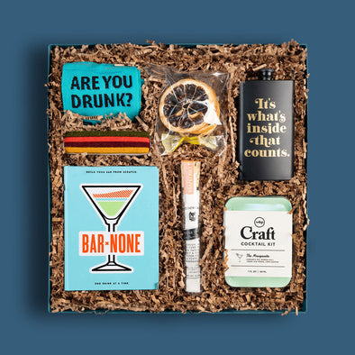 Goodly curated gift box with great cocktail-themed gifts for men, including a flask and bar mixers
