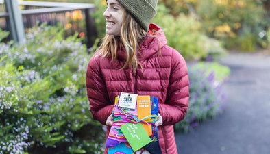happy woman holding packages of socks