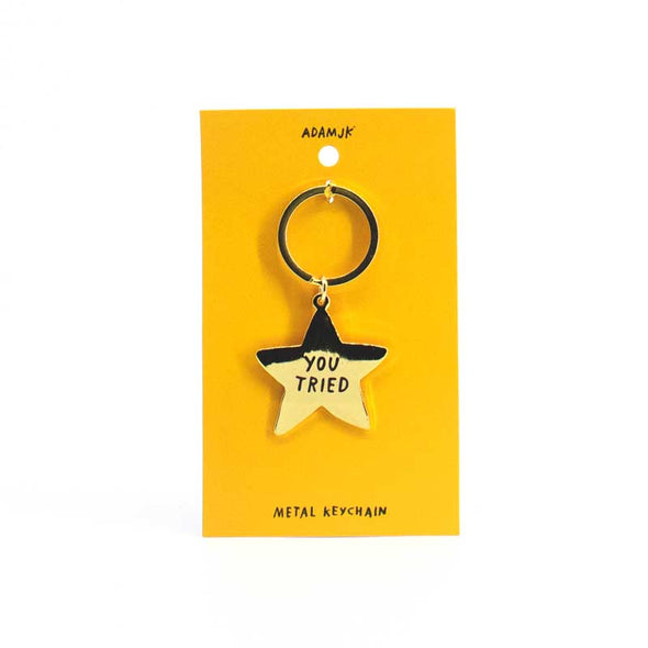 Gold-colored, star-shaped inspirational keychain that says, “You tried”