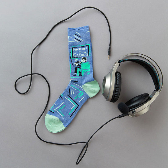 Flat lay view of funny men's video game socks that say, "F*ck off, I'm gaming"