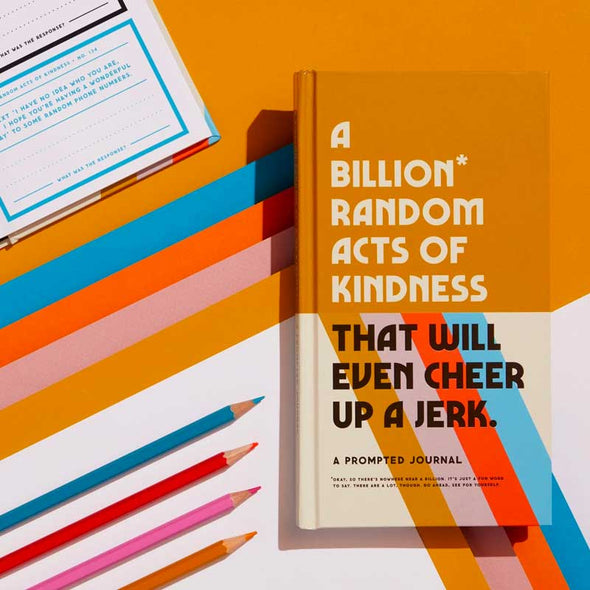 Funny journal filled with unusual and hilarious random acts of kindness alongside pencils and colored paper