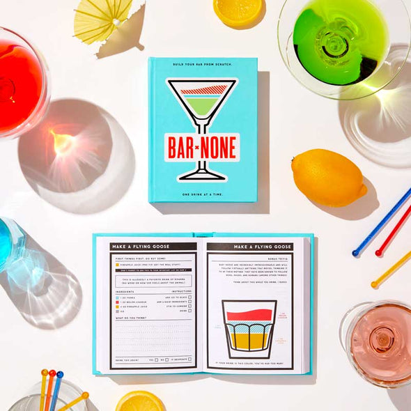 Cocktails alongside fun drinking book with hundreds of cocktail recipes and journaling space 