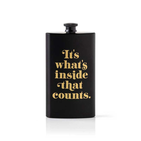 Matte black pocket flask with the words, “it’s what’s inside that counts” in gold letters