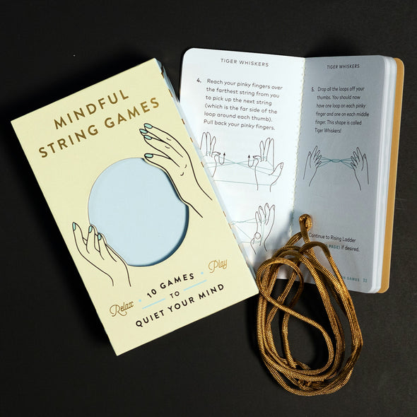 Opened unique meditation kit with string games and an instruction book