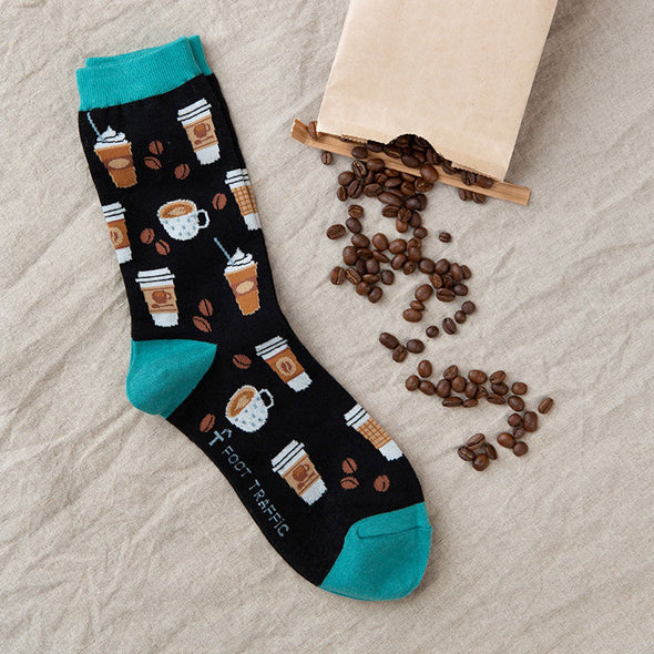 Coffee socks laying flat next to coffee beans