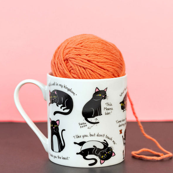 ball of yarn inside funny cat-themed mug