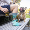 A man wearing funny beer socks that say, “In dog beers, I’ve had 1”