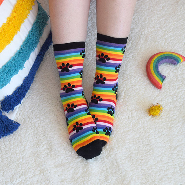 woman wearing cute rainbow stripe paw print socks
