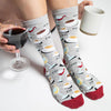 woman wearing funny socks with cups of coffee, glasses of wine and the words "am" and "pm"