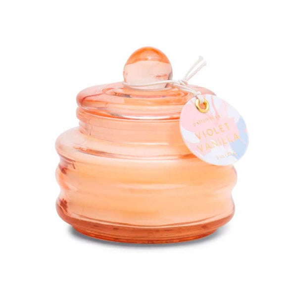 Scented candle in a small pink glass jar with lid
