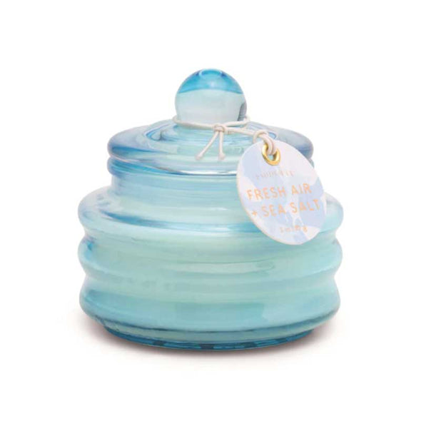 Scented candle in a small blue glass jar with lid