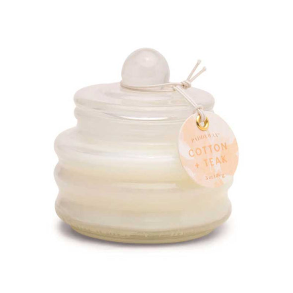 Scented candle in a small white glass jar with lid