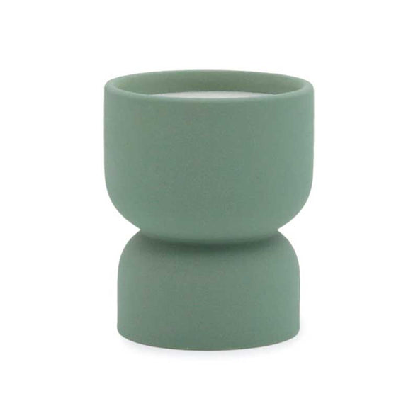 Scented candle in a matte green ceramic vessel