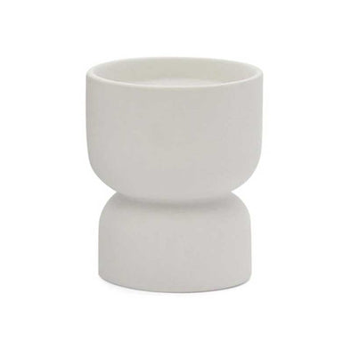 Scented candle in a matte white ceramic vessel