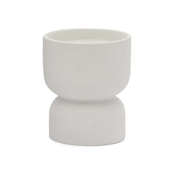 Scented candle in a matte white ceramic vessel