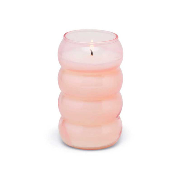 Scented candle in a pink ribbed glass vessel
