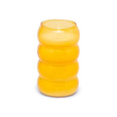 Scented candle in a yellow-orange ribbed glass vessel
