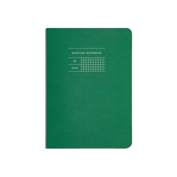 Classic notebook with green cover and gridded pages