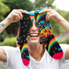 model holding up fun women's socks with sun, moon, stars and rainbows