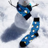 snowman wearing fun men's socks with penguins on them as a scarf