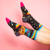 model wearing colorful women's socks with a pattern of stars, rainbows, the sun and the moon