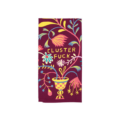 A funny dish towel with flowers and the phrase "Cluster fuck"