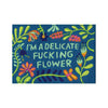 A close-up view of the tag that says, “Delicate fucking flower"
