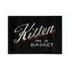 A close-up view of the tag that says, “Kitten in a basket”