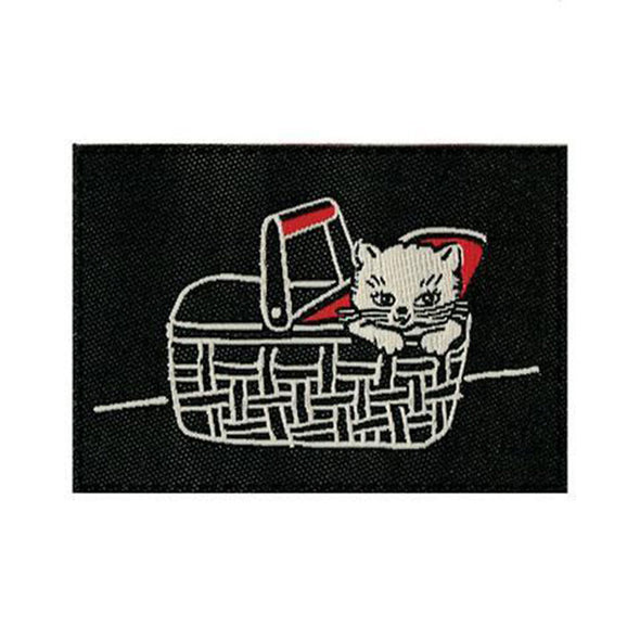 A close-up view of the second tag that has a kitten in a basket