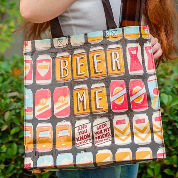 woman holding a funny tote bag with beer cans and the words “Beer me ... And you know what? Beer you, my friend. Beer you”