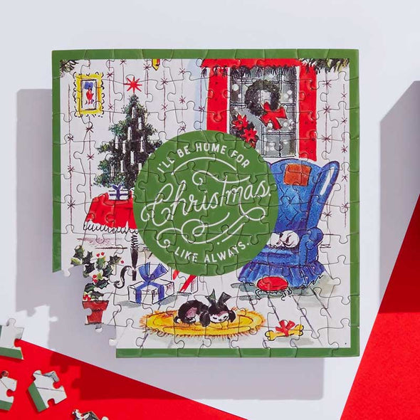 Jigsaw puzzle with a Christmas tree scene and the words, “I’ll be home for Christmas like always”