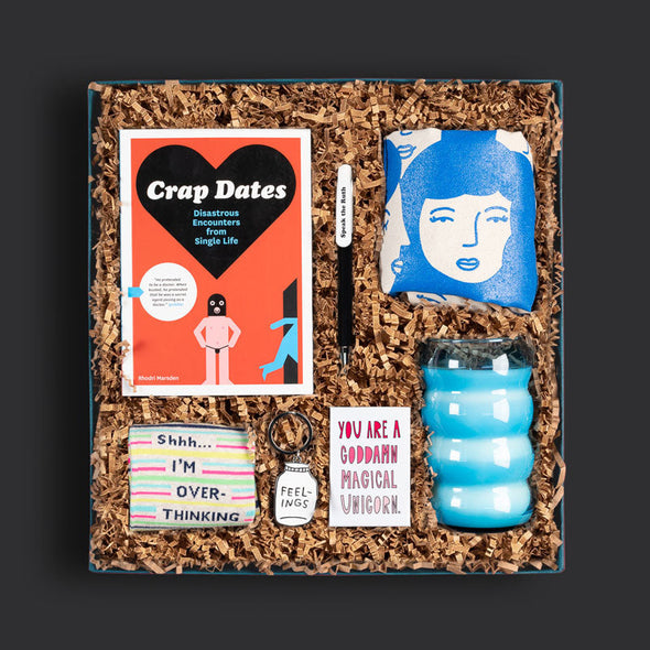 Goodly curated gift box with a tote bag, candle, funny book and other gifts for a modern woman