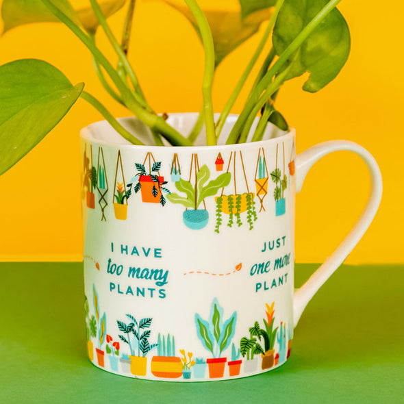 pothos sitting inside a plant-themed mug