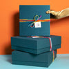 Stack of Goodly curated gift boxes, wrapped in yarn