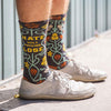 man wearing white shoes and socks with a cool pattern and the words, "hate will fucking lose"