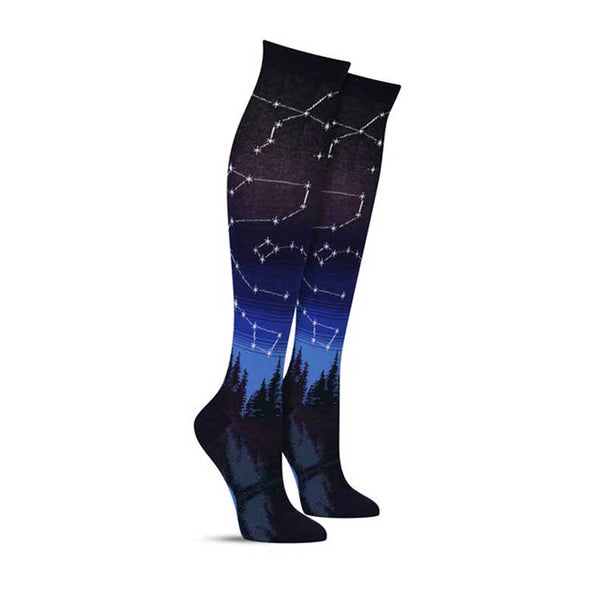 Knee high constellation socks for women, with a starry night sky scene over a lake