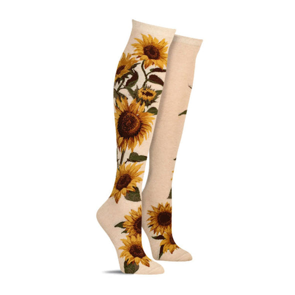 Cute women’s knee high socks with a pattern of large sunflowers against a solid background
