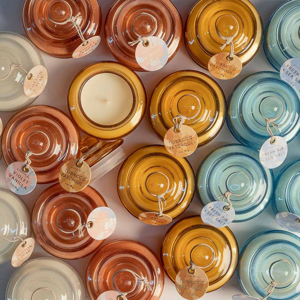 Assorted colors of small scented candles in glass jar with lid 
