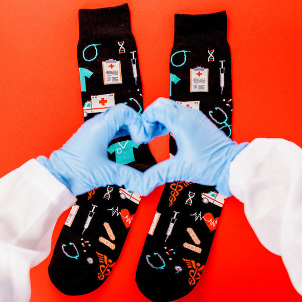 Flat lay view of cool men's socks that have a pattern of medical imagery