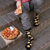 Man eating a slice of pizza and wearing cool pizza socks
