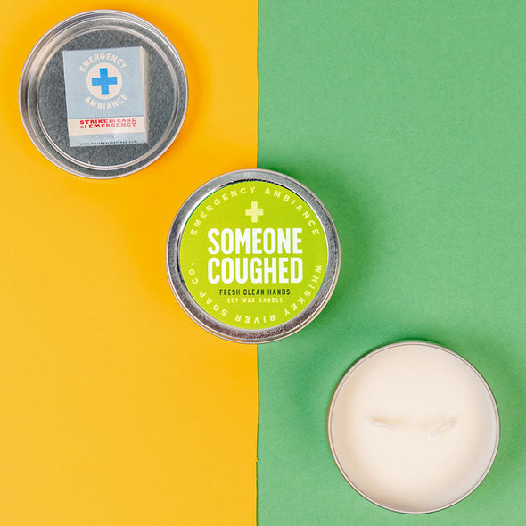 colorful view of funny candle tin that says, "someone coughed"
