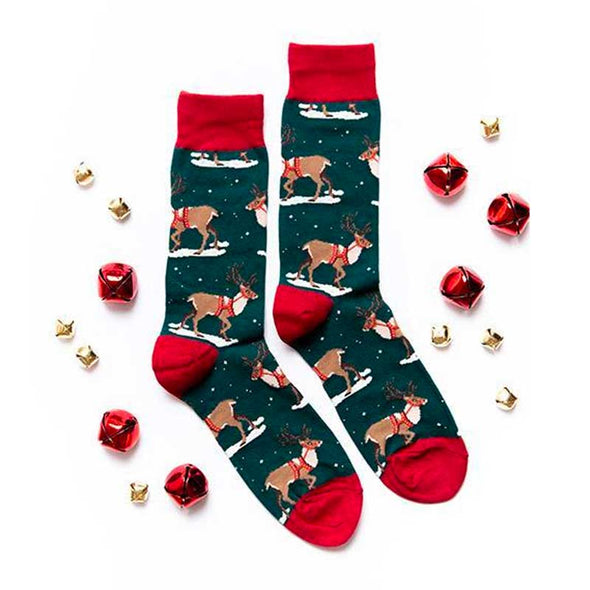 Flat lay view of various jingle bells and men's Christmas reindeer socks
