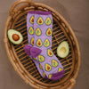 Flat lay view of fun women's food socks in lavender with avocado halves holding hands and smiling together